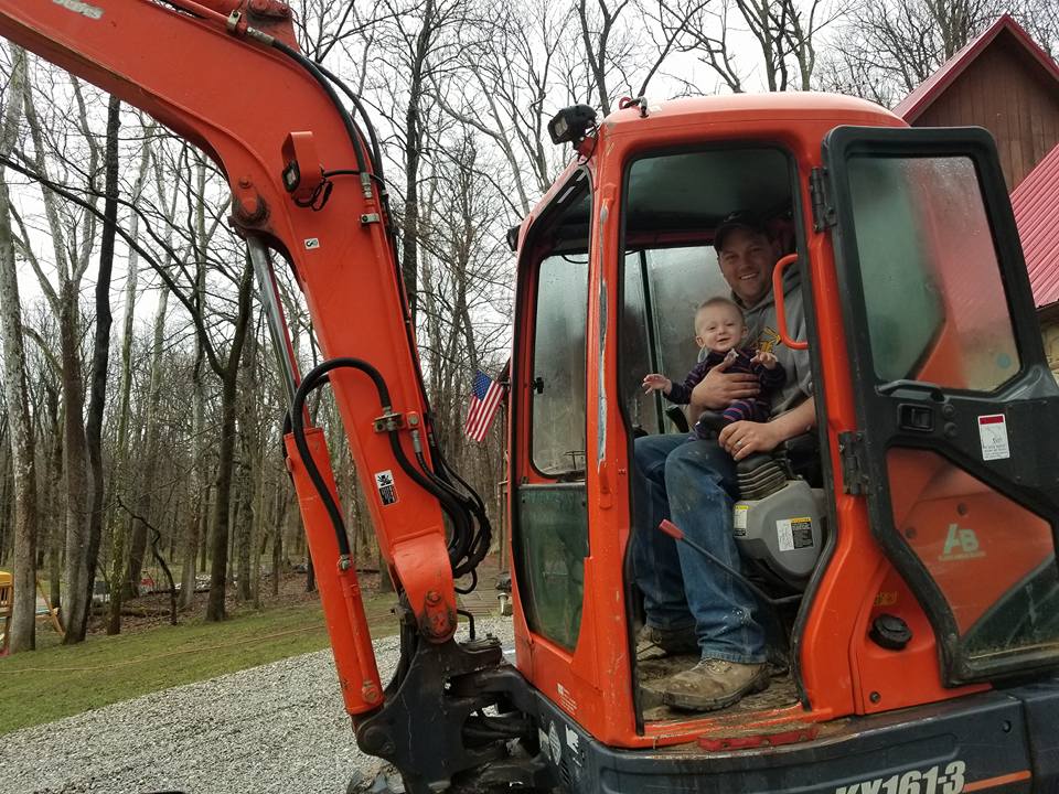 Scott taking his son along for the ride- it's never too early to start learning!